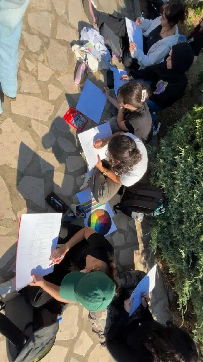 “Participants gathered in open green space during RKIF educational workshop”